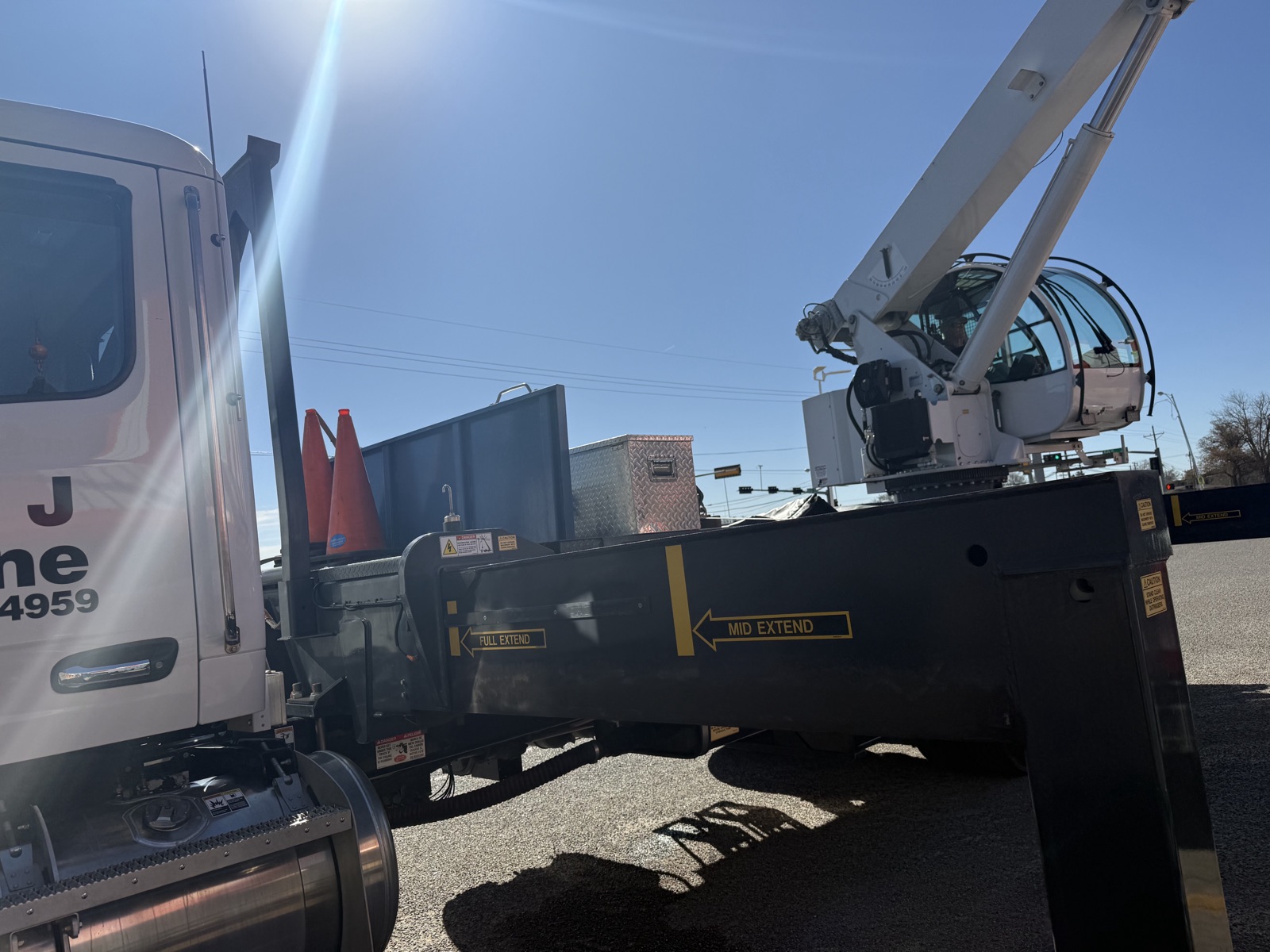 Crane truck setting a rooftop refrigeration unit in Lubbock